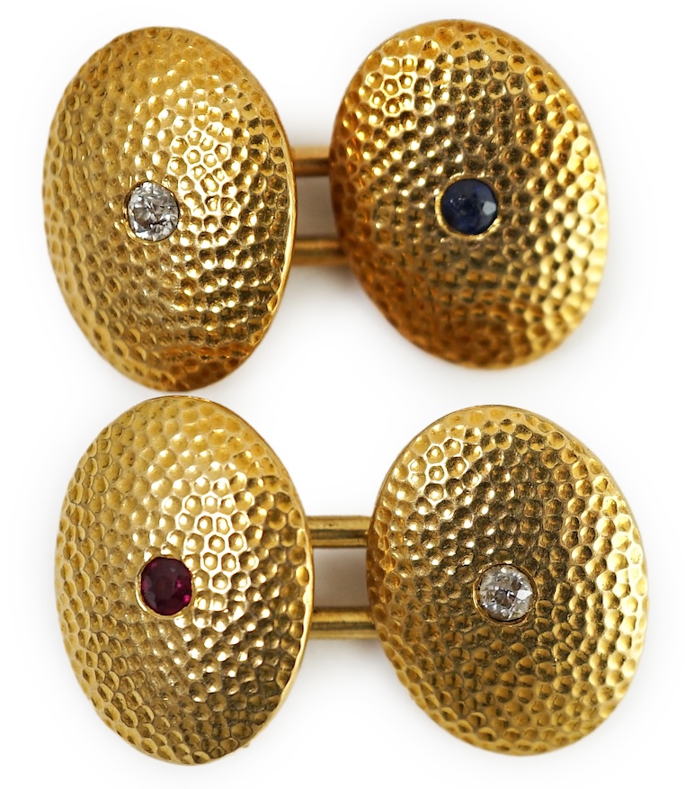 A pair of planished 18ct gold, ruby, sapphire and diamond set oval cufflinks